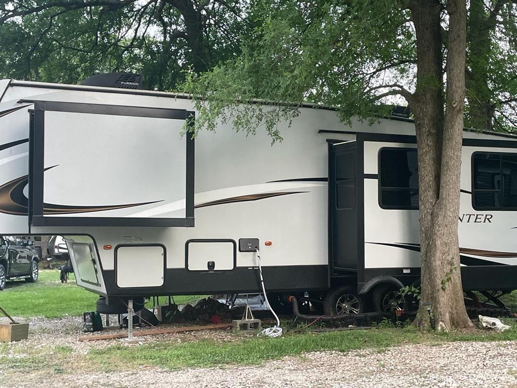 Large fifth-wheel RV with slide-out at Sugar Land RV Park