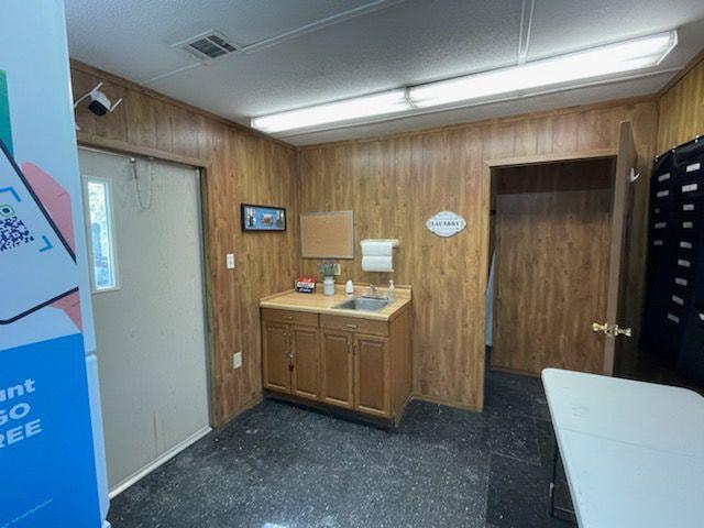 Laundry room interior with sink and cabinets at Sugar Land RV Park