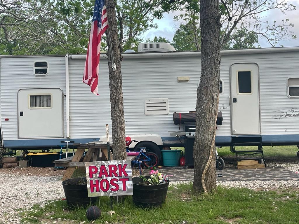 Park Host RV site with American flag at Sugar Land RV Park